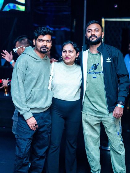 Posing with friends after a great set at White Lotus Club. It's always good to celebrate a successful night with the team.