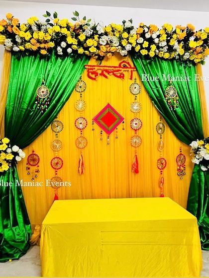 A wider view of the bohemian-style Haldi setup, showing the floral stands and the central seating arrangement.
