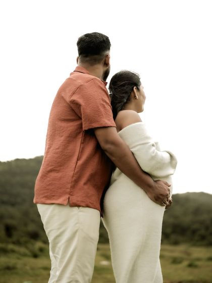 A portrait from behind, showing the couple embracing as they look out over the landscape. It symbolizes them facing the future together.