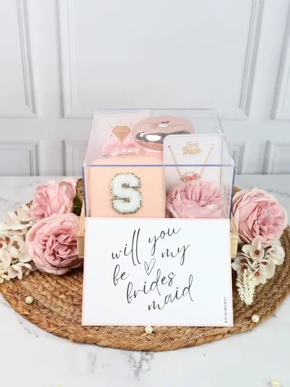 A chic bridesmaid proposal gift in an acrylic box. This set includes a personalized jewelry organizer and a necklace, complete with a "Will you be my bridesmaid?" card.