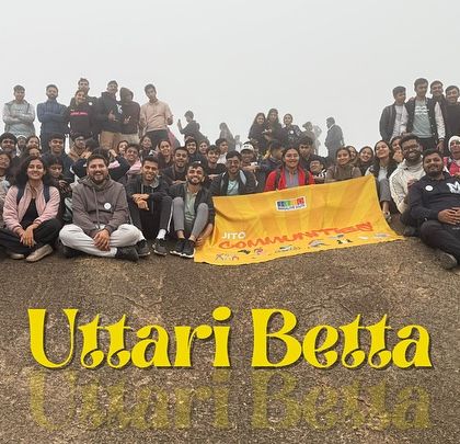A massive group of adventurers who joined us for the Uttari Betta trek, all smiles after reaching the summit.