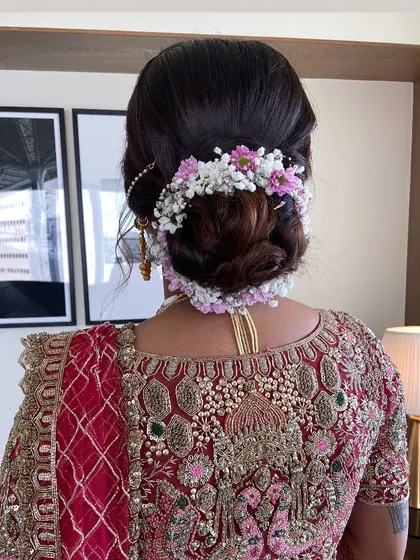 Another perspective of the intricate floral bun, showing the careful arrangement of flowers to create a crown-like effect.