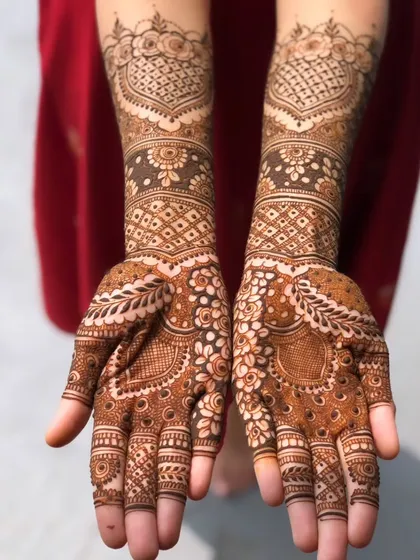 A beautiful design featuring heart-shaped patterns on the back of the hands. The mix of delicate vines and filled-in traditional work gives it a unique look.
