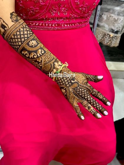 A close-up of a single arm, showing the detailed craftsmanship of a traditional design. The mix of jaali work, lotus bands, and elephant motifs is simply stunning.