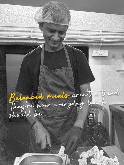 Balanced meals aren't a trend, they're how everyday lunch should be. Here's our chef carefully prepping fresh vegetables for the day's menu.