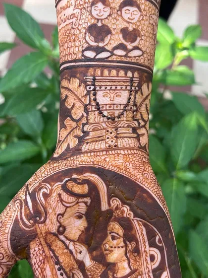 A close-up of a custom design featuring a portrait of Raghavendra Swamy's Vrindavan. Incorporating spiritual figures that are important to the bride makes the mehendi a true blessing.