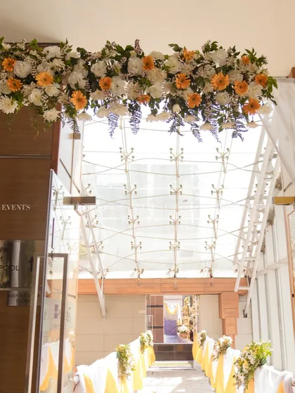 A beautiful floral archway at the entrance of the venue, welcoming guests to the Haldi celebration.