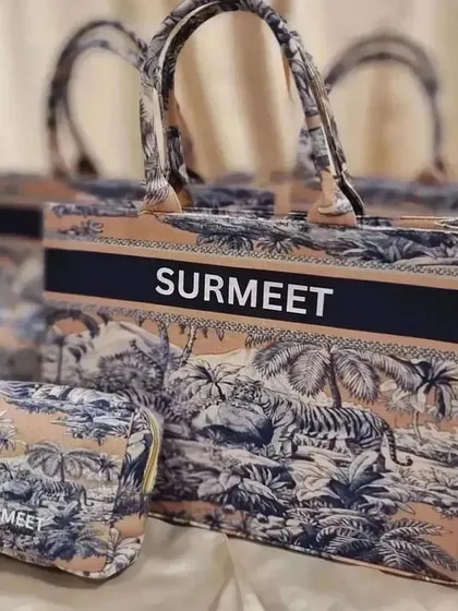 A close-up of the personalised tote bag and matching pouch from our anniversary gift set.