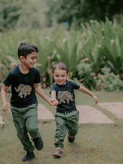 The bond between brothers is something special. I captured this candid moment of them running hand in hand during an outdoor sibling photoshoot. My goal is to photograph these connections as they truly are, full of energy and affection.