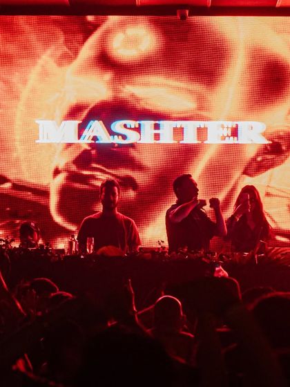 A powerful shot of me on stage, with a massive visual of a face behind me. The production value at these events is always top-notch.