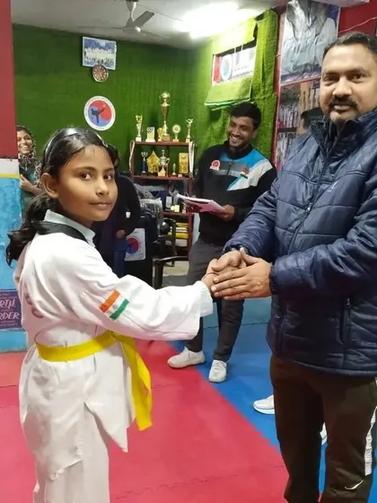 Congratulating my student on her promotion. She has shown great improvement in her techniques.