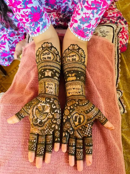 This custom baby shower mehandi includes 'Mom to be' and 'Dad to be' titles, a 'Boy or Girl?' query, and a baby in a cradle. It's a fun way to celebrate the parents-to-be.