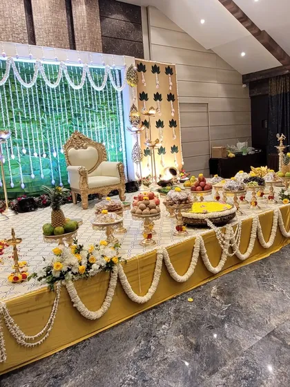 The 'seer' or gift table is a key part of a traditional baby shower. I arrange it with a variety of fruits, sweets, and gifts on decorative stands, ensuring it is both abundant and beautifully presented.