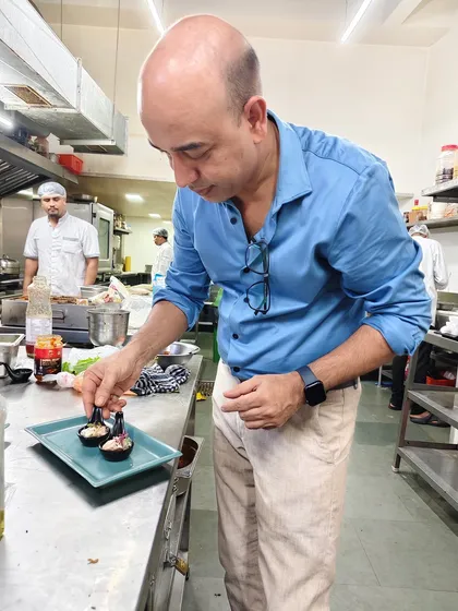 In the kitchen, every detail matters. A glimpse of me focused on the intricate task of plating, because excellence is in the details.