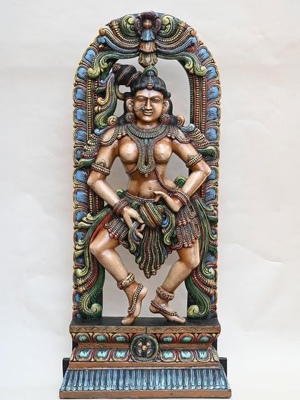 The 5-foot wooden dancing Apsara, shown against a clean background to emphasize her form and the intricate, colorful details of her attire and the surrounding arch.