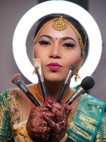 A fun shot of Arpitha with my makeup brushes, showing the playful and happy atmosphere I create.