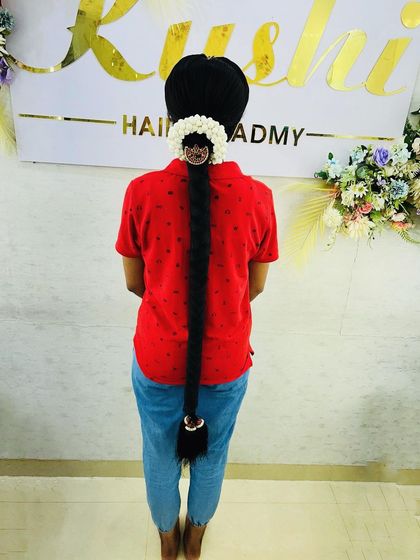 A very long, traditional bridal braid styled for a muhurtham look. I use extensions and accessories to create impressive length and volume, a key feature of South Indian bridal hair.