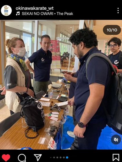 A screenshot from the official Okinawa Karate World Tournament Instagram page, showing our team members at the registration desk.