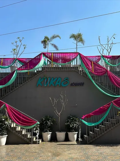 The entrance to a venue decorated with vibrant pink and green drapes for a Haldi or Mehendi function, setting a festive tone from the moment guests arrive.