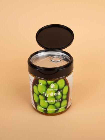 The Lasoda Pickle jar with its lid open, showing the pull-tab for freshness.