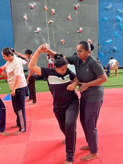 Our instructors provide personalized, hands-on guidance during every session. Here, an instructor corrects a participant's form on a wrist-hold escape, ensuring the technique is learned correctly and can be applied effectively in a real-life situation.