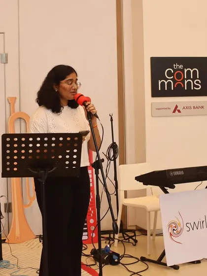 A student vocalist delivering a confident performance at the MuSo showcase. Our vocal lessons help students develop their voice and stage presence.