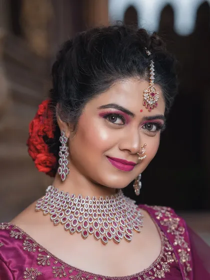 A close-up of a reception look with a magenta lehenga and diamond jewellery.