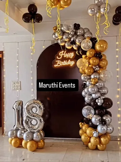 An 18th birthday deserves some glam. I designed this chic black, gold, and silver balloon arch against a dark backdrop, with a glowing neon "Happy Birthday" sign and giant light-up numbers to make the moment shine.
