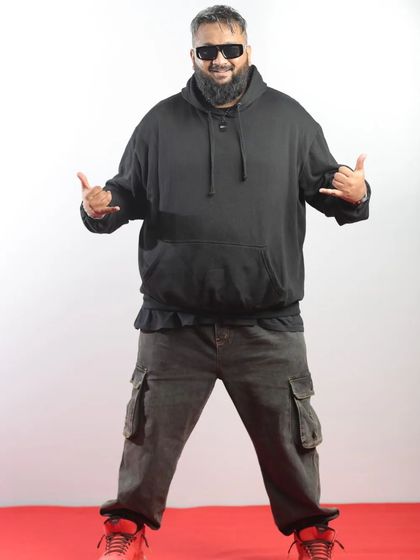 Rapper All OK in his signature hoodie, bringing his unique energy to the red carpet.