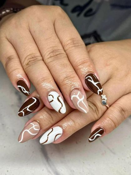 A modern abstract design with brown, beige, and white swirls. This 'latte art' style is very popular and chic.