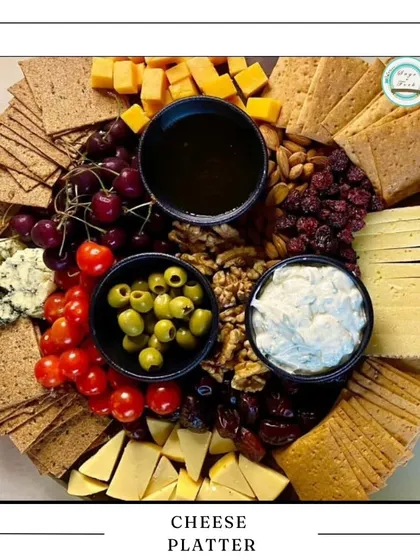 For Raksha Bandhan, consider my exquisite cheese platter. It's a sophisticated and delicious gift, featuring a variety of cheeses, crackers, olives, and fruits that your sibling is sure to love.