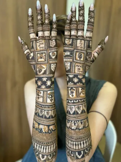 For brides looking for something unique, I create modern designs like this one. It features personalized symbols and names arranged in a grid pattern, offering a contemporary twist on traditional bridal mehndi.
