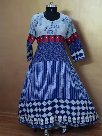 I love playing with prints, and this long Anarkali combines multiple blue and white patterns in one harmonious design. The red embroidered band adds a pop of contrasting color.