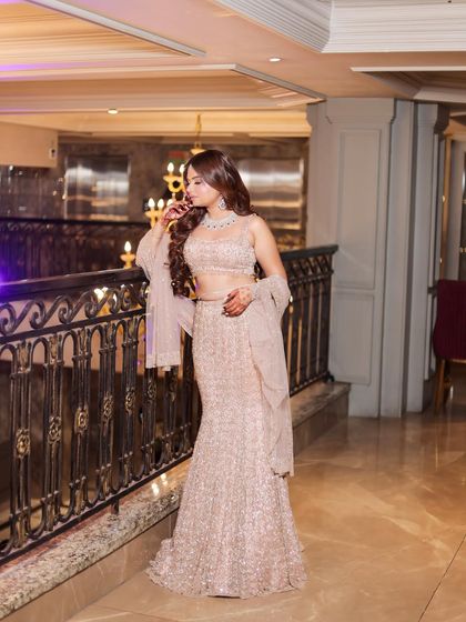 This pose highlights the flow and design of the lehenga and the delicate sleeves. Every detail is considered when creating the perfect shot.