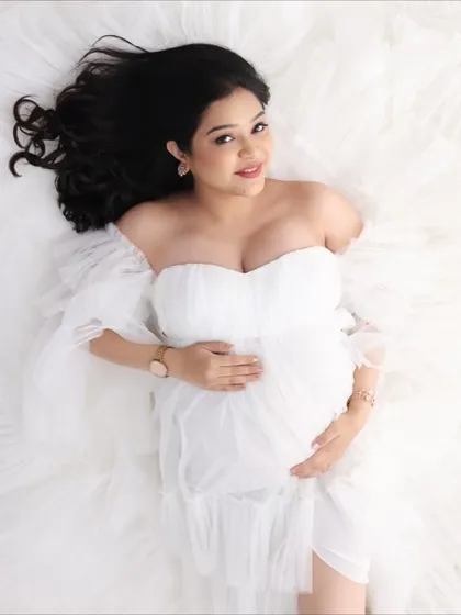 An ethereal maternity photoshoot. The all-white theme is complemented by soft, beautiful makeup and hair.