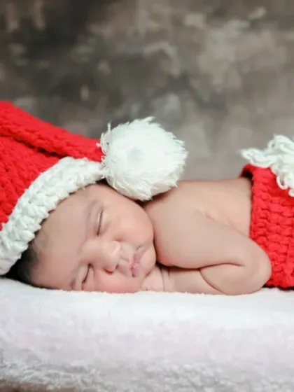 The sweetest little Santa, dreaming of his first Christmas. We offer festive themed shoots for your newborn's first holidays.
