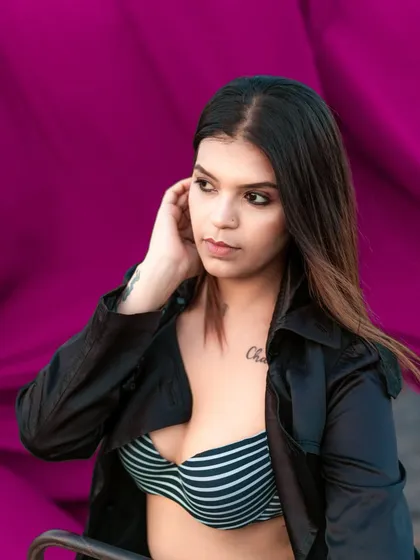 A stylish portrait against a bold pink backdrop. The model's expression is confident and cool, perfect for a modern fashion portfolio.