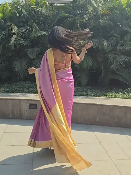 A candid moment showing the beautiful flow and lightness of the saree fabric. Even a traditional silk saree can feel playful and fun when styled the right way.