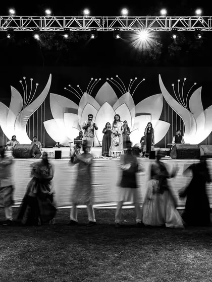 An artistic shot of the Sangeet stage, using a slow shutter speed to capture the motion of the dancers.