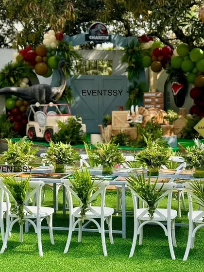 Welcome to Jurassic Park. This setup shows how I transform an entire space, with a detailed backdrop, themed foliage, and perfectly arranged seating for young party guests.