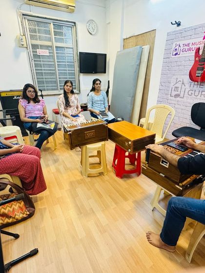 A wide view of our Hindustani vocal class in session. The setup with harmoniums and focused students reflects our commitment to providing an authentic and effective learning experience.