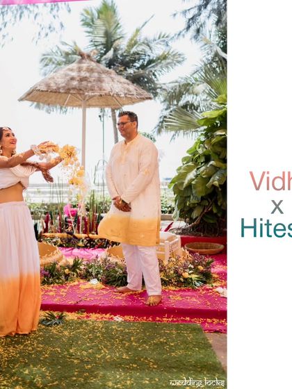 The bride playfully showers her groom with flower petals during their Haldi ceremony, a perfect candid shot full of life.