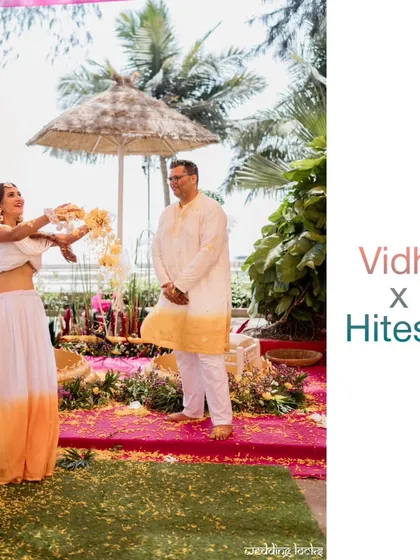 The bride playfully showers her groom with flower petals during their Haldi ceremony, a perfect candid shot full of life.