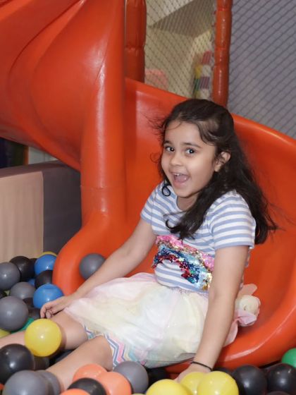 Sliding into fun with a huge smile! Our orange slide offers another exciting way for kids to enter the ball pit.
