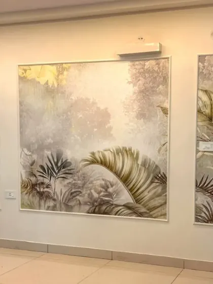 We created a sophisticated and modern look in this living area by installing wallpaper within framed panels. This technique adds architectural detail and turns a simple tropical leaf design into a triptych art piece.