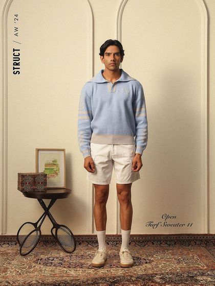 The Open Turf Sweater from Struct, styled for a lookbook with a vintage sports theme.