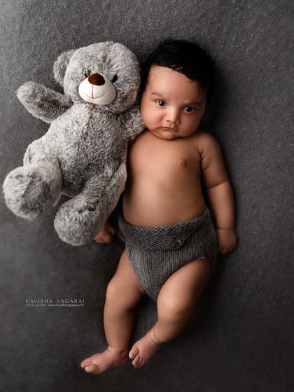 This one-month-old baby boy gives a grumpy but adorable look while cuddling his teddy bear. Bringing a favorite toy can make the session even more personal.