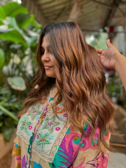 A side view showing the soft layers and warm brown balayage. This is a perfect example of elegant and timeless wedding hair.