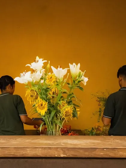 Our staff carefully arrange fresh sunflowers and lilies. We believe fresh flowers bring life and beauty into our spaces.