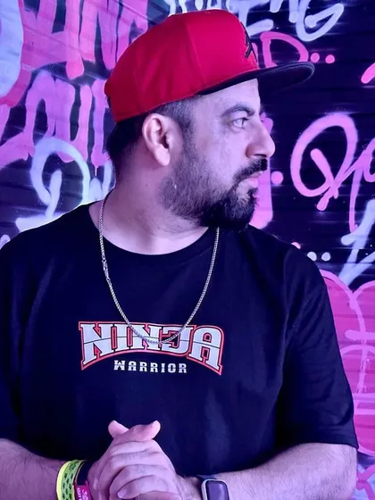 A candid shot of me against the vibrant graffiti.